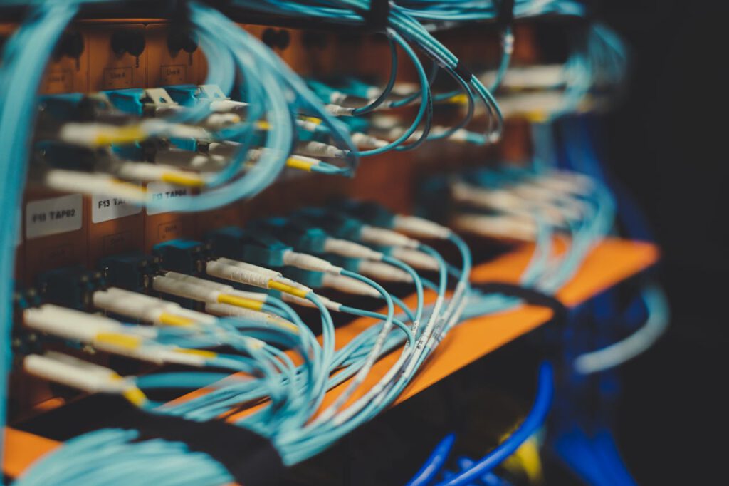 pexels-photo-4657256 Closeup of many cables with blue wires plugged in modern switch with similar adapters on blurred background in modern studio