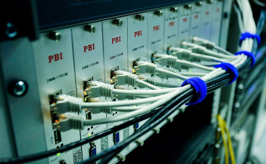 pexels-photo-6466143 Close-up of ethernet cables connected to a network switch panel in a data center.